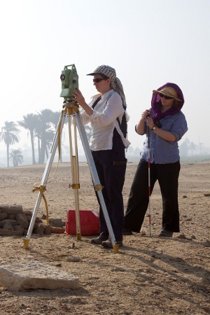 Hannah Pethen and Sarah Doherty surveying with a total station